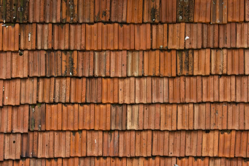 Aged clay roof tile texture in close-up