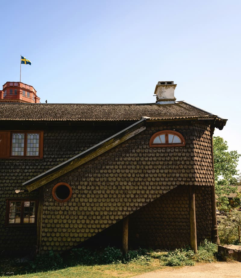 Peach bungalow with dark asphalt shingle roof