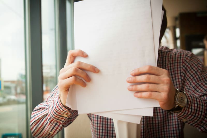 Person holding printed documents